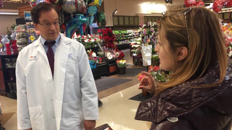 Doctor talking to a patient in a grocery store aisle