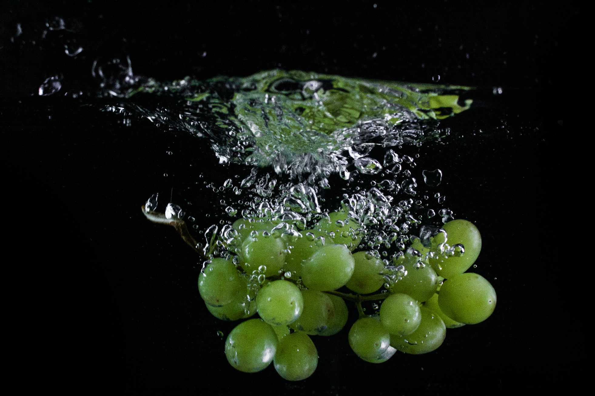 A bunch of grapes in water.
