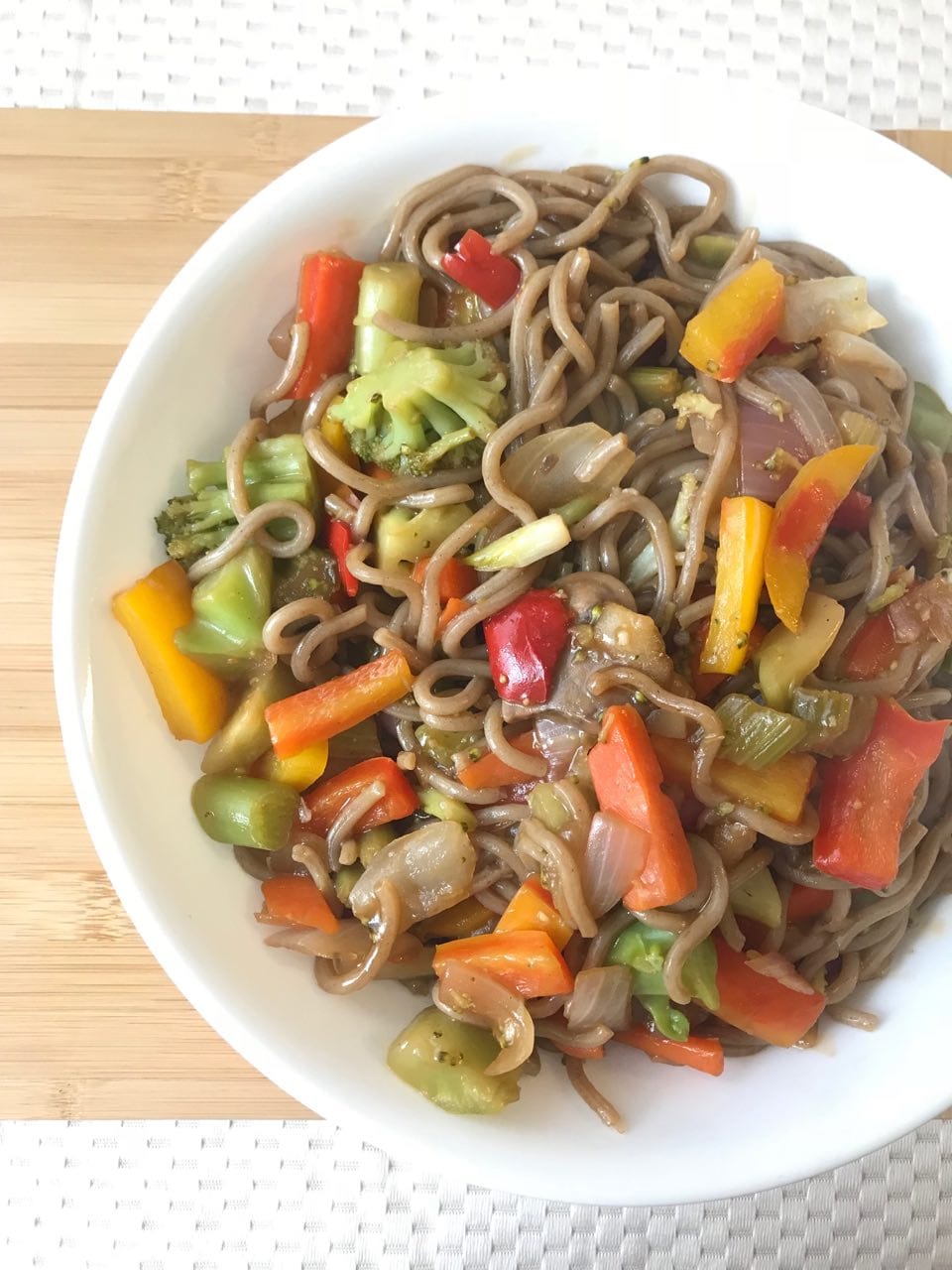 Bowl of vegetable stir fry on a cutting board