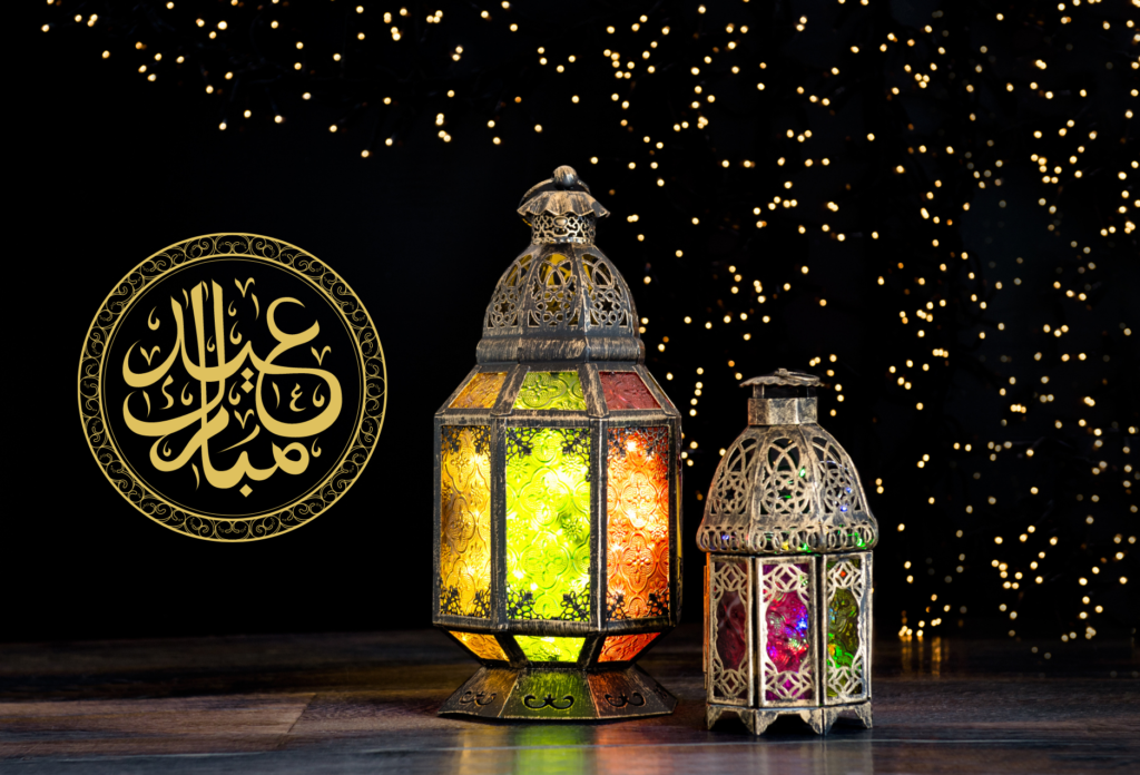 Learn about Eid. A starry black backdrop with two Eid/Muslim lanterns and arabic calligraphy reading Eid Mubarak.